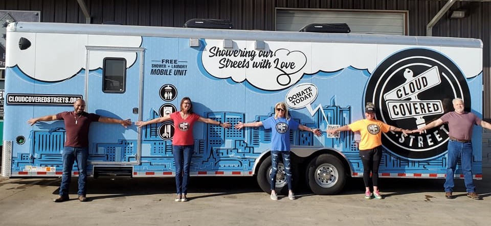 Cloud Covered Streets staff in front of the shower truck in arlington texas